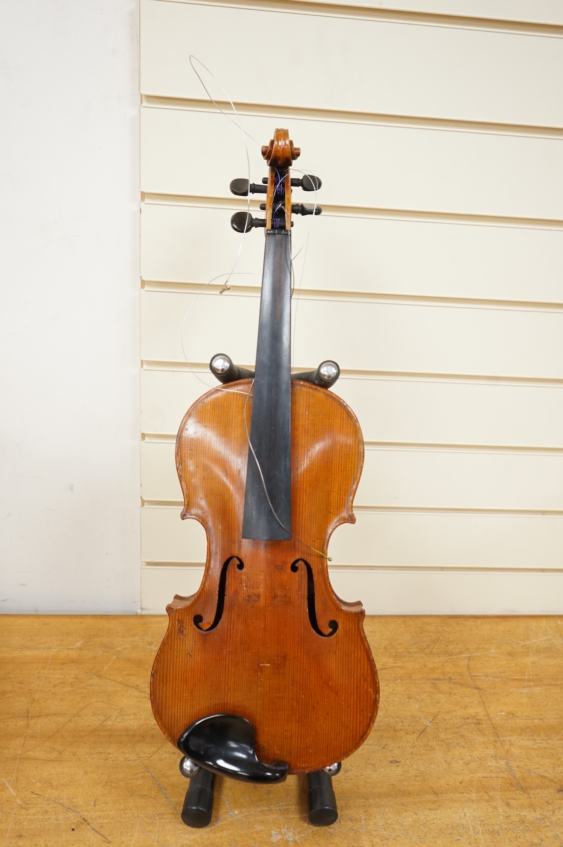 Four violins; a German Dresden violin, together with further two German violins, and a Saxony violin, three in cases or the remains of cases.